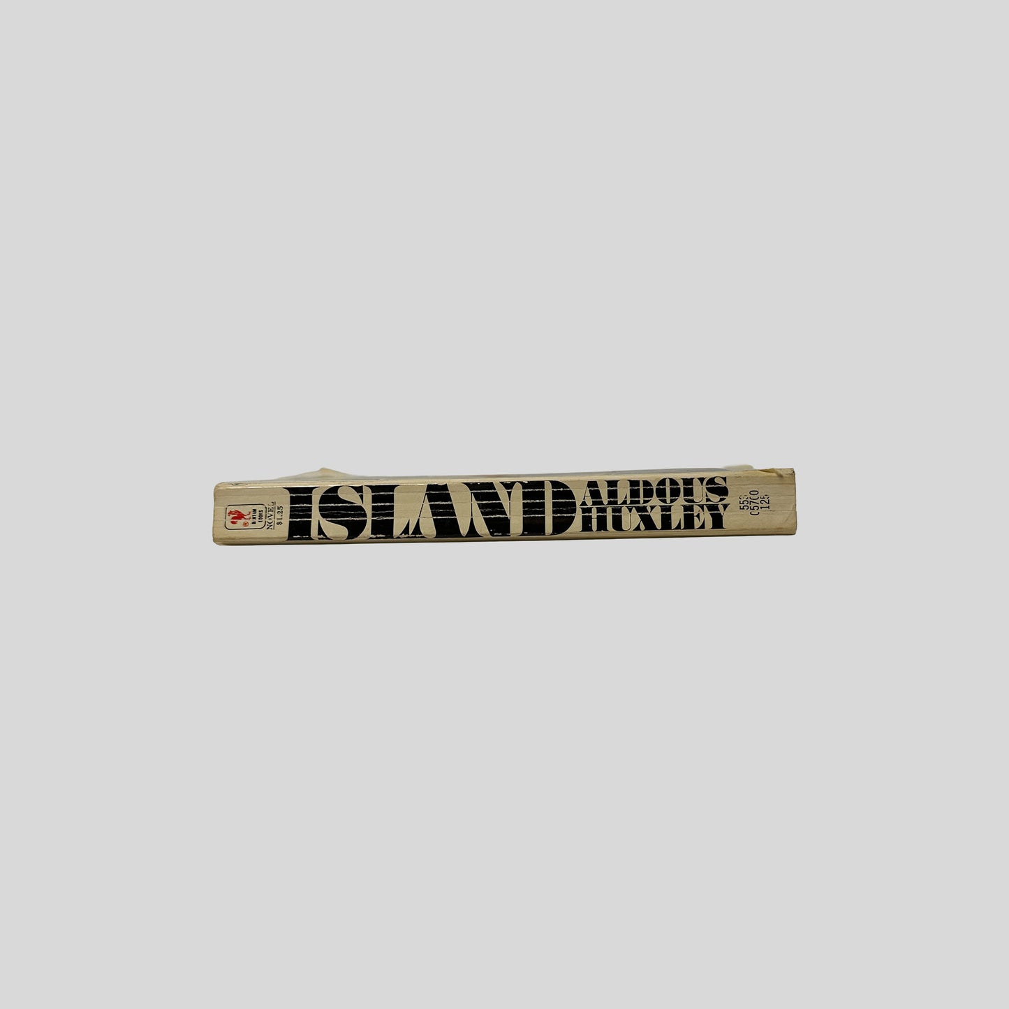 The tan-colored spine of the Bantam book "Island" by Aldous Huxley, showing vertical title text and the publisher's rooster logo.