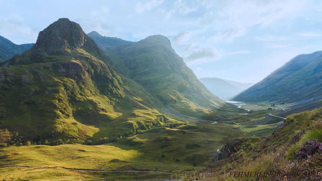Serene view of moors with vibrant greenery and tall, jagged peaks, reflecting imagery from fiction books like Outlander and inspiration for for places like Middle-earth.