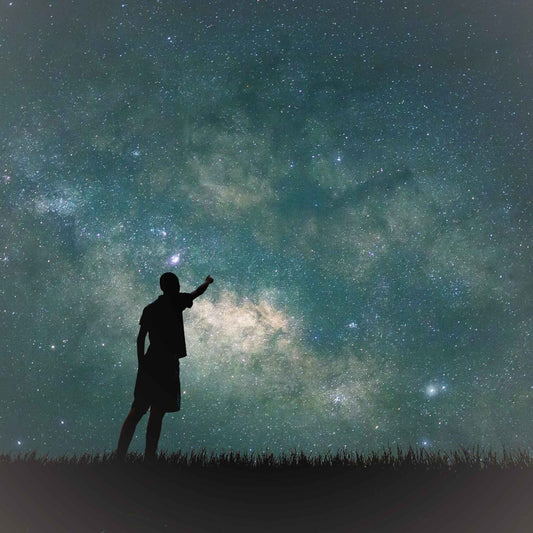 Silhouette of a person looking at the stars.