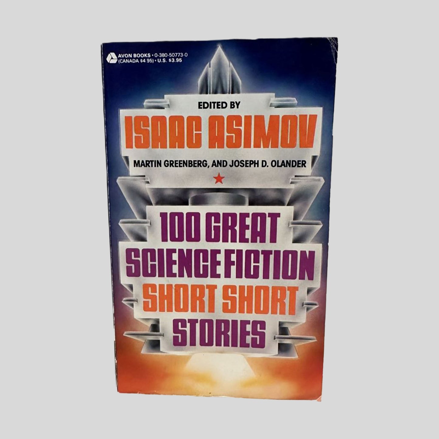 100 Great Science Fiction Short Short Stories edited by Isaac Asimov book cover. Features a white and grey textured background with a red and blue geometric design framing the central text. The title is printed in bold magenta and black block lettering, with Isaac Asimov's name prominently displayed in large orange font at the top.