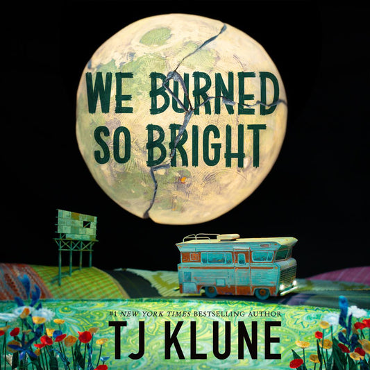 A large, cracked, parchment-textured moon hangs in a black sky with the title 'We Burned So Bright' written across it in dark teal. Below, a miniature teal and orange RV sits in a vibrant, patchwork-quilt landscape filled with tiny red and blue wildflowers. The author’s name, TJ Klune, is prominently displayed at the bottom.