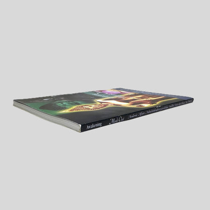 Side-angle view of 'Awakening: Monk Chat' resting on a neutral background. The screen captures the bold title and university name on the spine, reflecting the academic press design of MCU University Chiang Mai. The layout emphasizes the spiritual significance of the work, showcasing the clean edges and authentic binding of this rare Thai Buddhist publication.