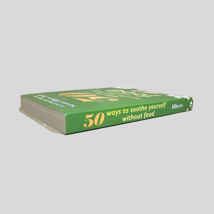 Spine of the 50 Ways to Soothe Yourself Without Food paperback. Displays the author and title in white and light yellow font against a solid green background. The visual confirms a Like New condition with a perfectly straight, uncreased spine.