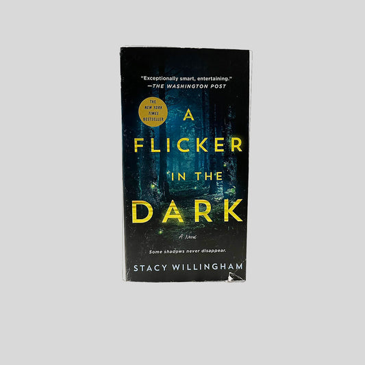 Front cover view of A Flicker in the Dark by Stacy Willingham centered on a neutral light gray background. Small tear and creasing at the right bottom corner.