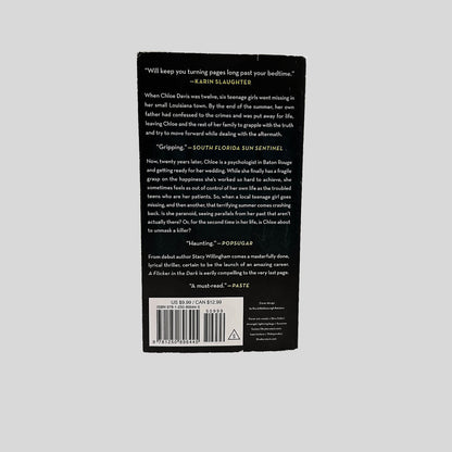 Back cover view of A Flicker in the Dark by Stacy Willingham centered on a neutral light gray background. Minor chipping is present around the edges from normal wear.