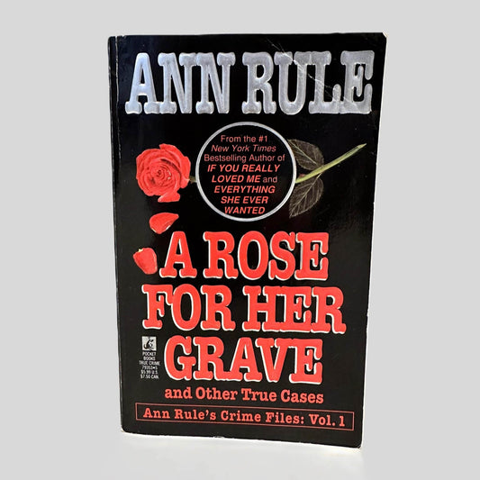 Front cover view of A Rose For Her Grave by Ann Rule centered on a neutral light gray background. 