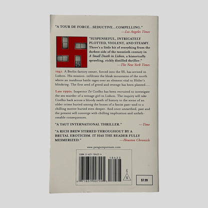The back cover of the paperback "A Small Death in Lisbon," showing several literary reviews over a graphic of a window frame forming a red swastika.