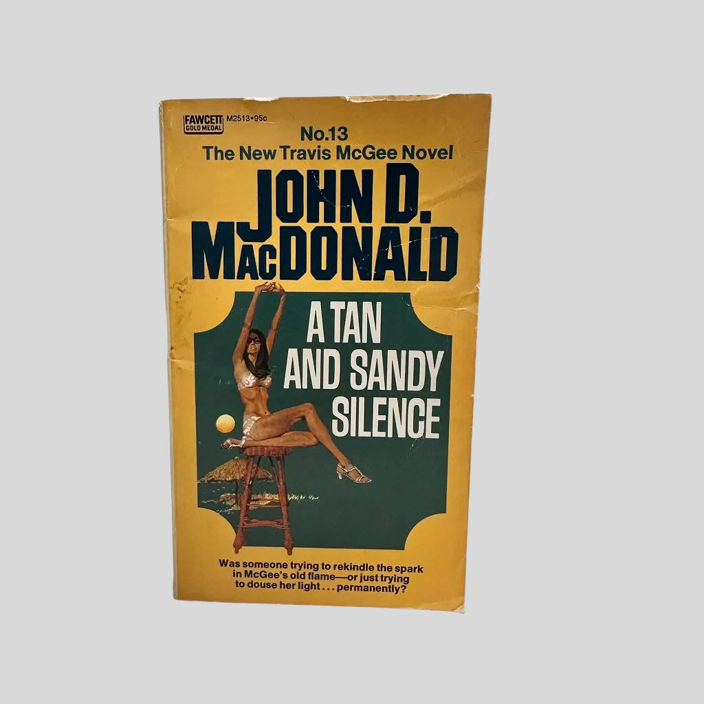 Front cover view of A Tan and Sandy Silence by John D. MacDonald centered on a neutral light gray background. Cover shows chipping and creasing.