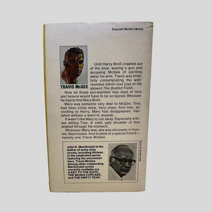 Back cover view of A Tan and Sandy Silence by John D. MacDonald centered on a neutral light gray background. 