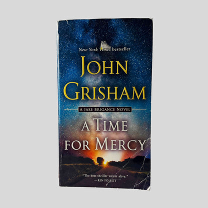 Front cover view of A Time for Mercy by John Grisham centered on a neutral light gray background. Creasing and chipping present in the bottom left corner.
