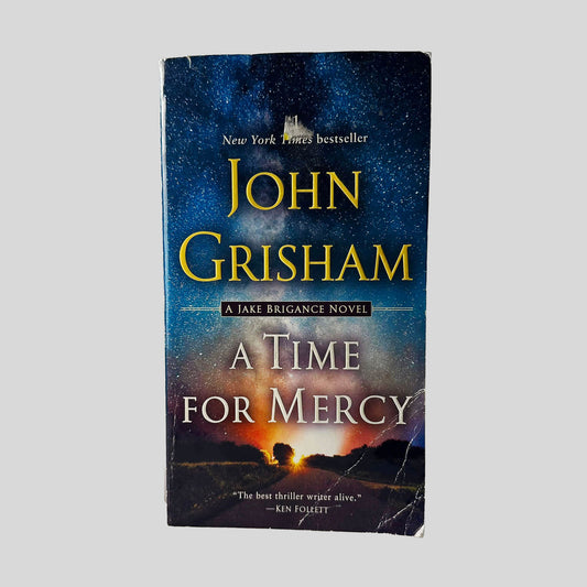 Front cover view of A Time for Mercy by John Grisham centered on a neutral light gray background. Creasing and chipping present in the bottom left corner.