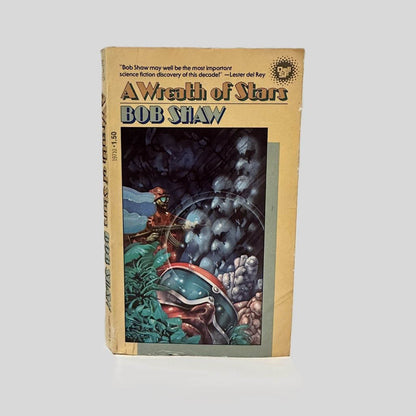 Front cover view of A Wreath of Stars by Bob Shaw centered on a neutral light gray background. Normal wear from age, creasing at bottom left corner.