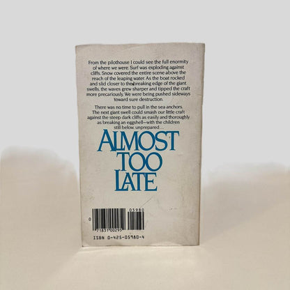 Back cover view of Almost Too Late by Elmo Wortman centered on a neutral light gray background. Creasing is present around the edges. Minor creasing on the left side corners.