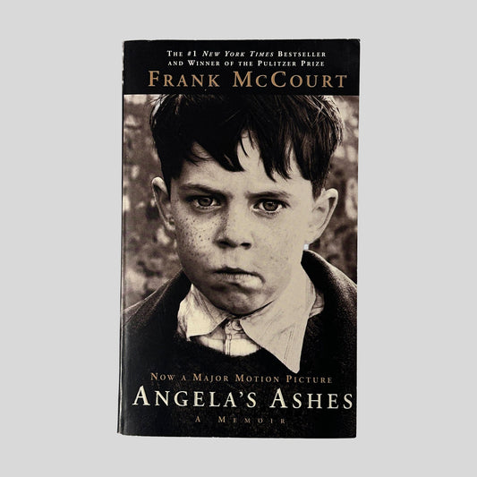 The front cover of "Angela's Ashes" by Frank McCourt, featuring a sepia-toned close-up photograph of a serious, freckled young boy.