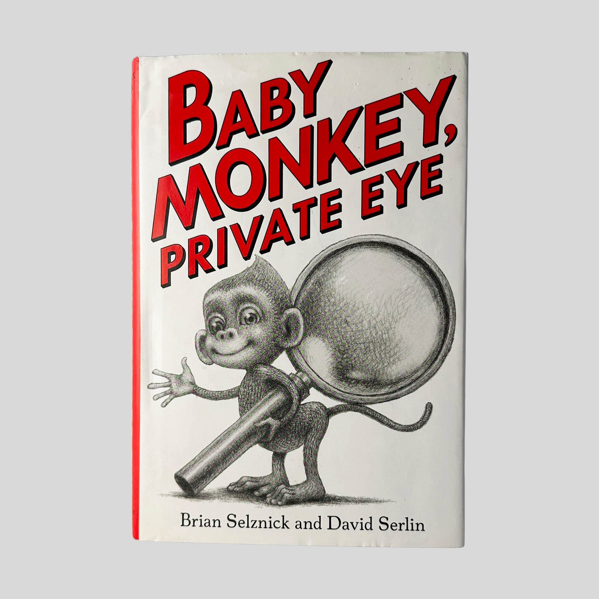 Front cover view of Baby Monkey, Private Eye by Brian Selznick & David Serlin centered on a neutral light gray background. Dust jacket is present and shows no damage.