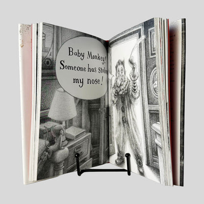 Inside page view of Baby Monkey, Private Eye by Brian Selznick & David Serlin centered on a neutral light gray background. Pages are tight and crisp.