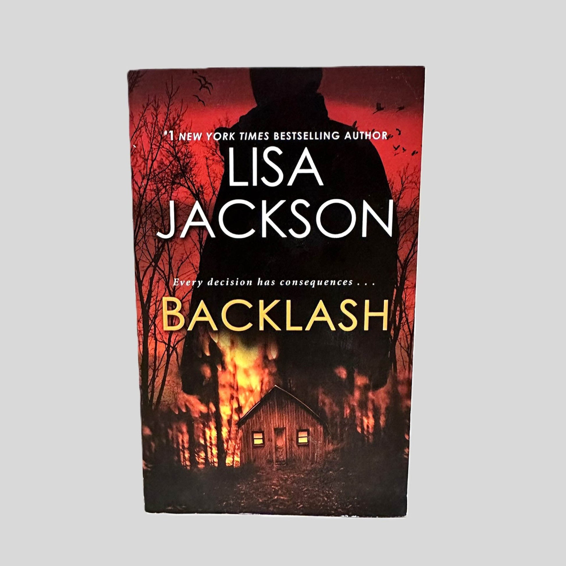 Front cover view of Backlash by Lisa Jackson centered on a neutral light gray background. 