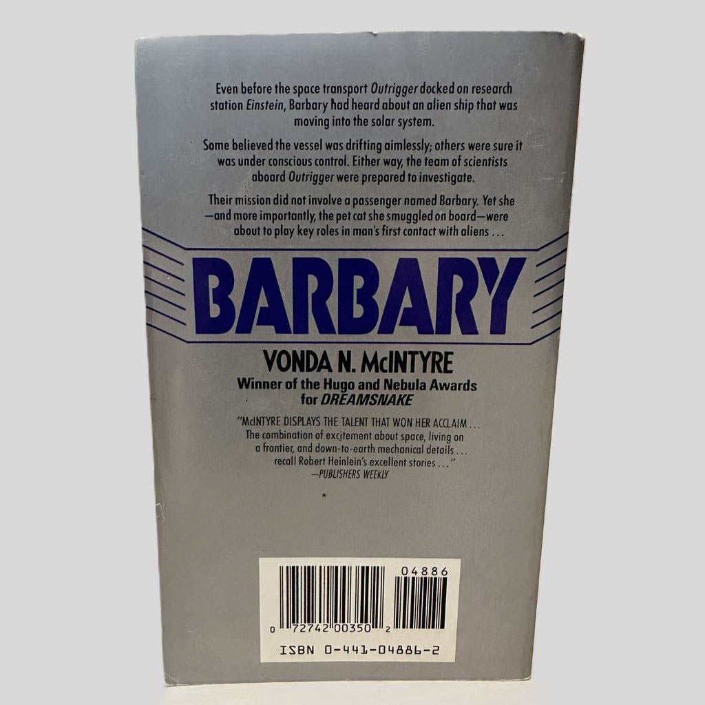 Back cover view of Barbary by Vonda N. McIntyre centered on a neutral light gray background.  Minor chipping along the top edge. 