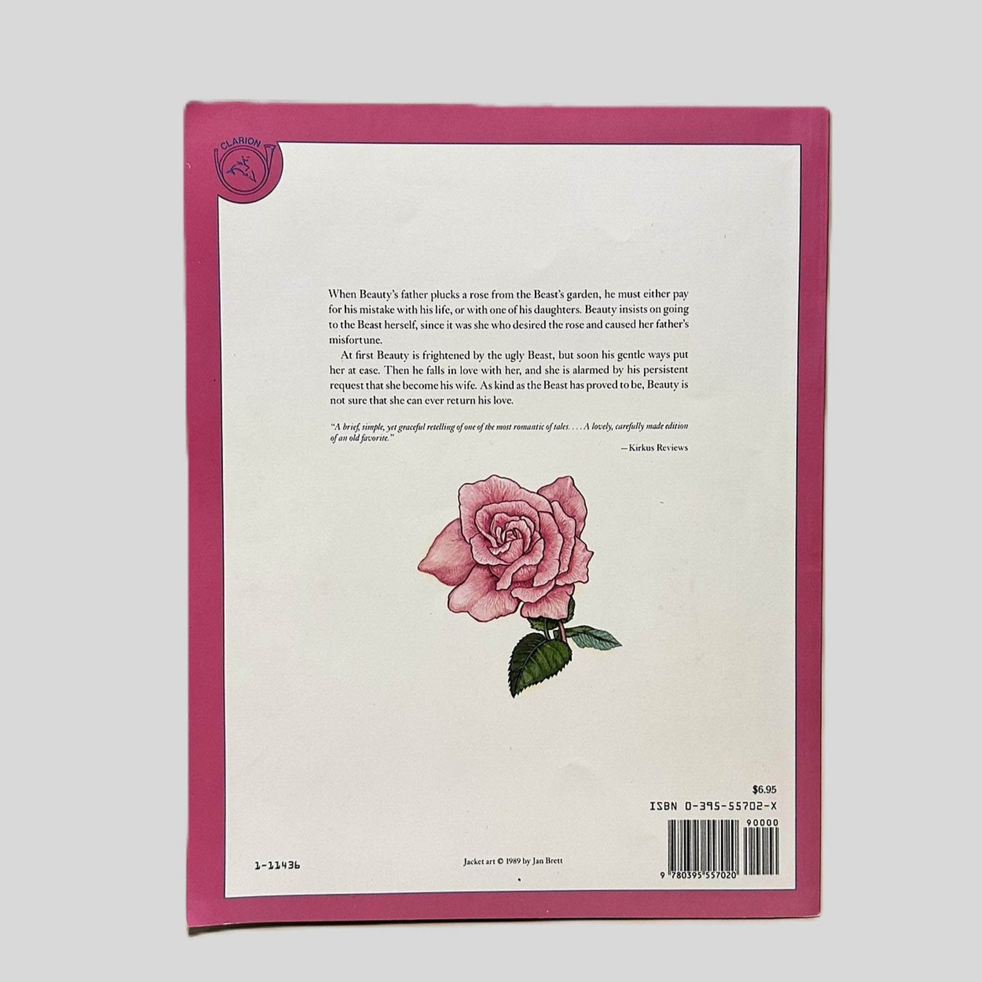 Back cover view of Beauty and the Beast Retold and Illustrated by Jan Brett centered on a neutral light gray background. Minor chipping along the top edge.