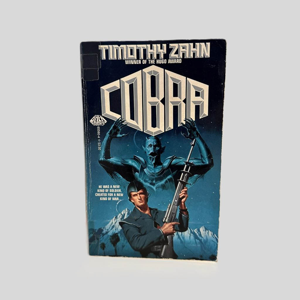 Front cover view of COBRA by Timothy Zahn centered on a neutral light gray background. Normal chipping around the edges from age. Cover art is vibrant.