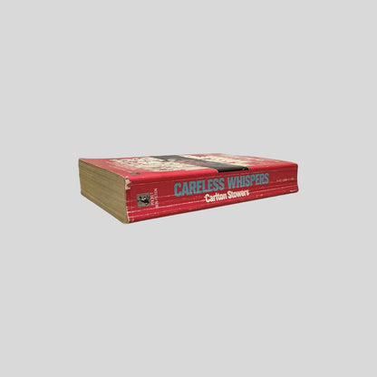 Close-up spine view of Careless Whispers by Carlton Stowers centered on a neutral light gray background. Spine shows creasing.