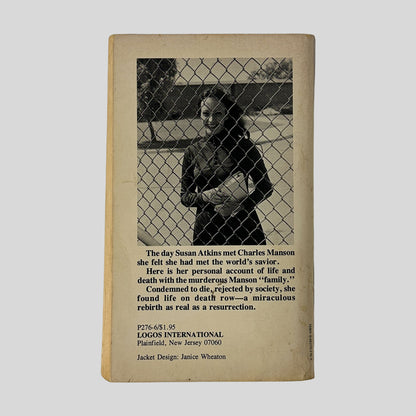 The back cover of the book, featuring a photograph of Susan Atkins smiling behind a chain-link fence, accompanied by a brief summary of her life and "miraculous rebirth."