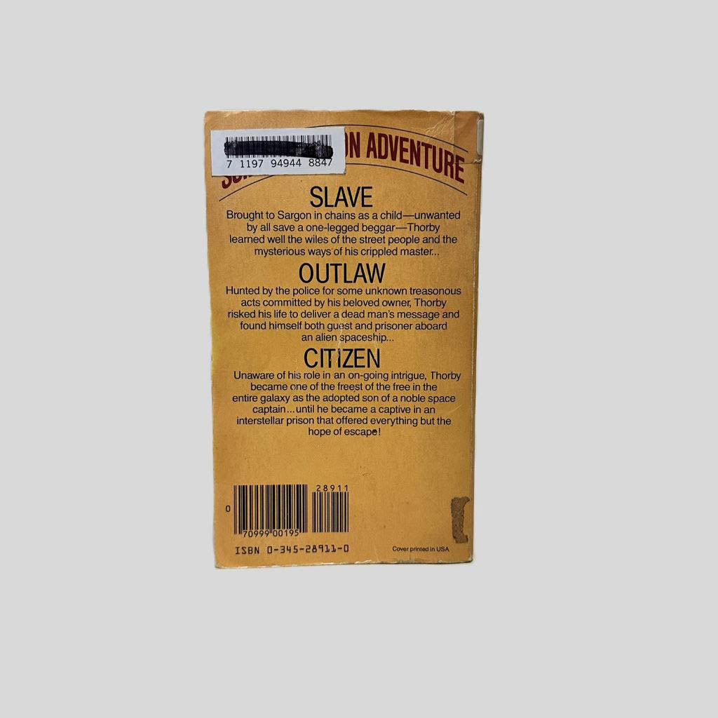 Back cover view of Citizen of the Galaxy by Robert A. Heinlein centered on a neutral light gray background. Chipping around the edges from normal wear and age. Library barcode sticker in the top left corner, colored over with black ink.