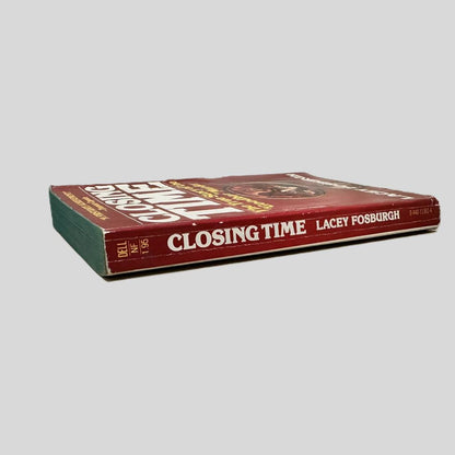 Close-up spine view of Closing Time by Lacey Fosburgh centered on a neutral light gray background. Spine shows creasing and minor bumping.