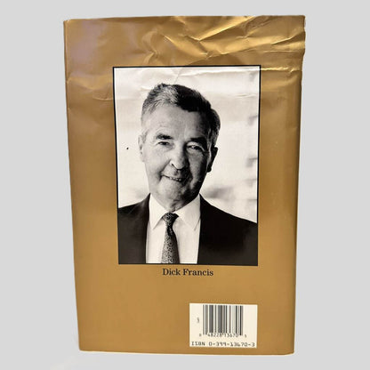 Back cover view of Comeback by Dick Francis centered on a neutral light gray background. Dust jacket is present and shows creasing on the top right.