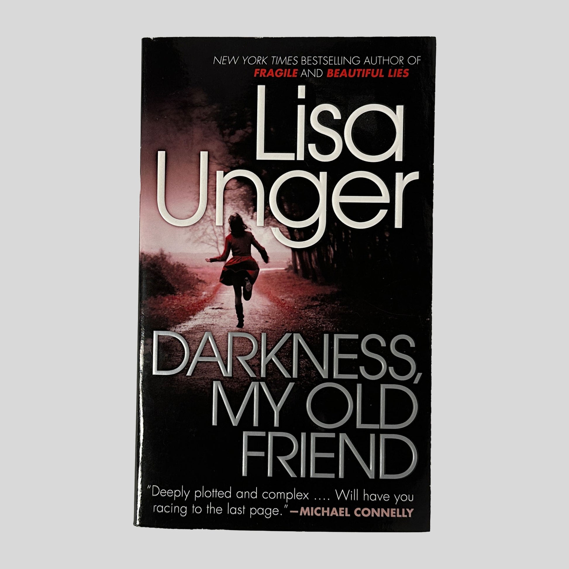 Front Cover: This crisp, "Used - Like New" paperback edition of Lisa Unger’s Darkness, My Old Friend is presented against a clean, neutral background, showcasing its chilling and cinematic design.