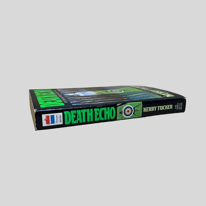 Close-up spine view of Death Echo by Kerry Tucker centered on a neutral light gray background. Spine is square, shows minimal creasing.