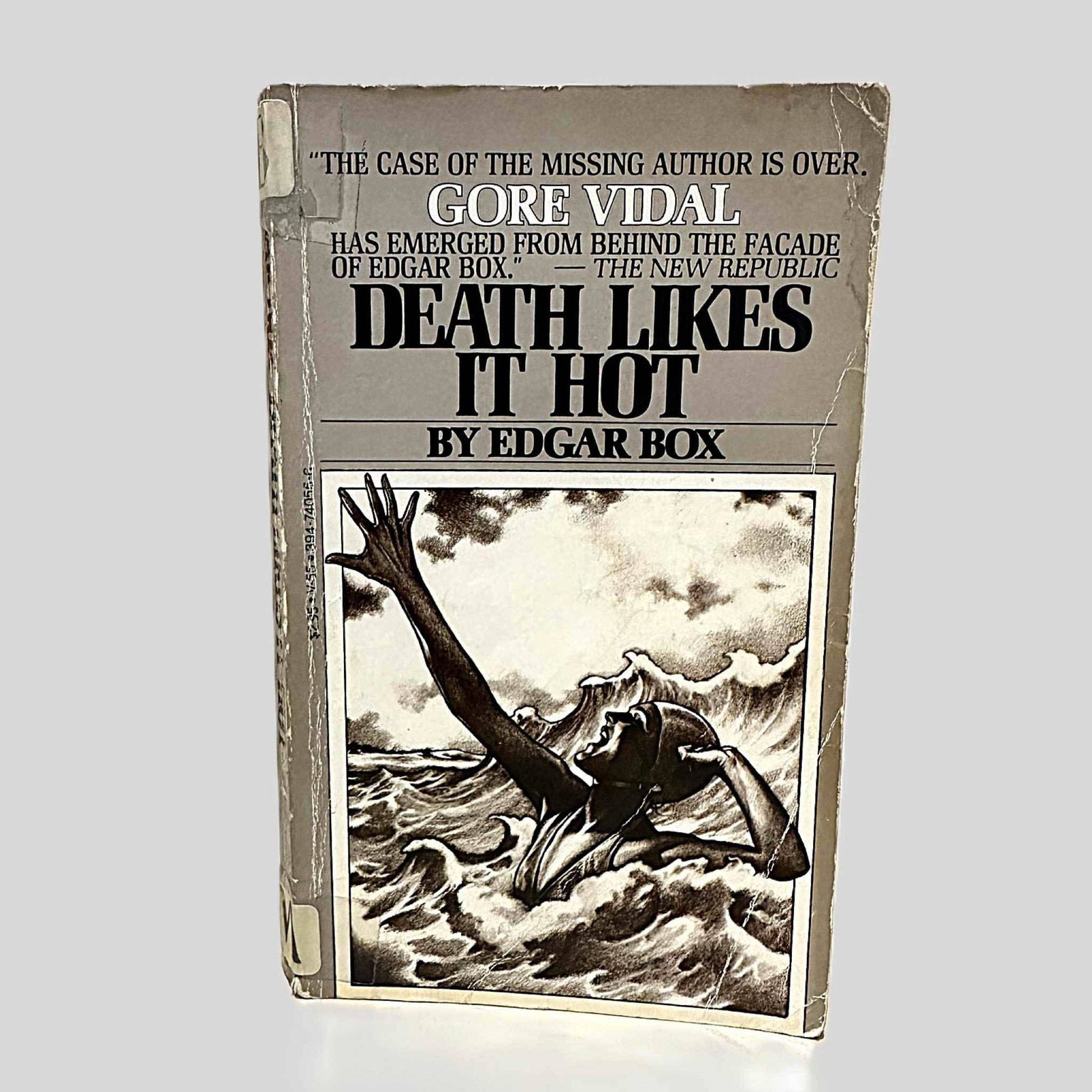 Front cover view of Death Likes It Hot by Edgar Box centered on a neutral light gray background. Cover shows creasing and chipping. 