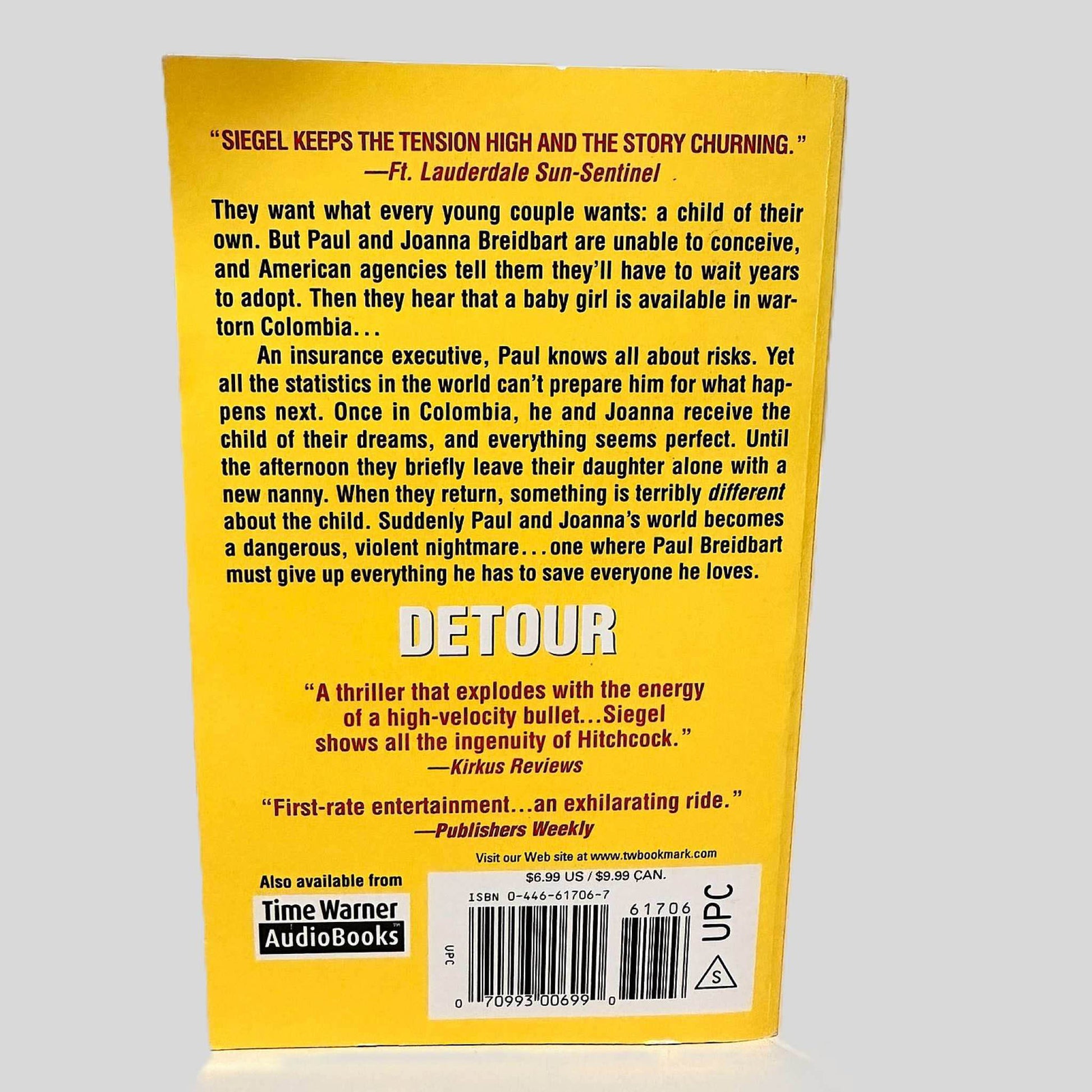 Back cover view of Detour by James Siegel centered on a neutral light gray background. Upper right corner curves out.