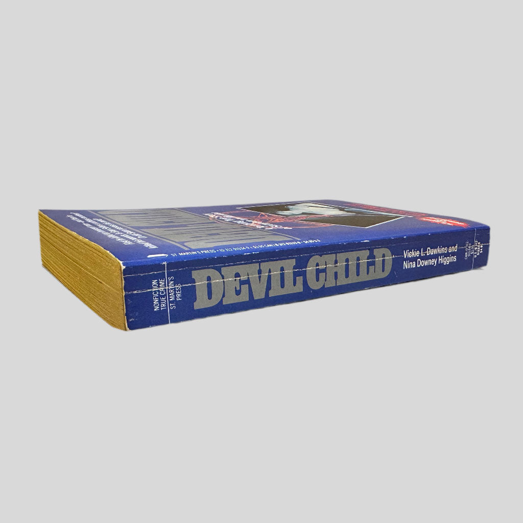 View of the spine of The Devil Child. The spine is straight with normal creasing from age.