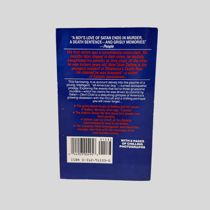 Back cover of The Devil Child by Dawkins and Higgins. The cover is blue with red and white font. The lower corner says "with 8 pages of chilling photographs."