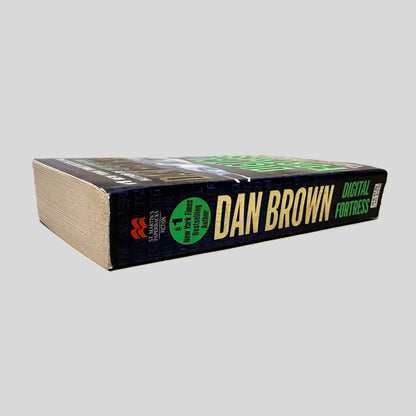 Close-up spine view of Digital Fortress by Dan Brown centered on a neutral light gray background. Spine is square and shows no creasing. Pages lay flat.