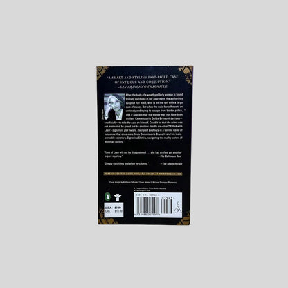 Back cover view of Doctored Evidence by Donna Leon centered on a neutral light gray background. 