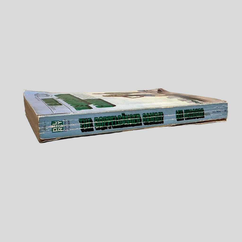 Close-up spine view of Doppelganger Gambit by Lee Killough centered on a neutral light gray background. Spine shows creasing and chipping at the top and bottom of the spine. Pages lay flat.