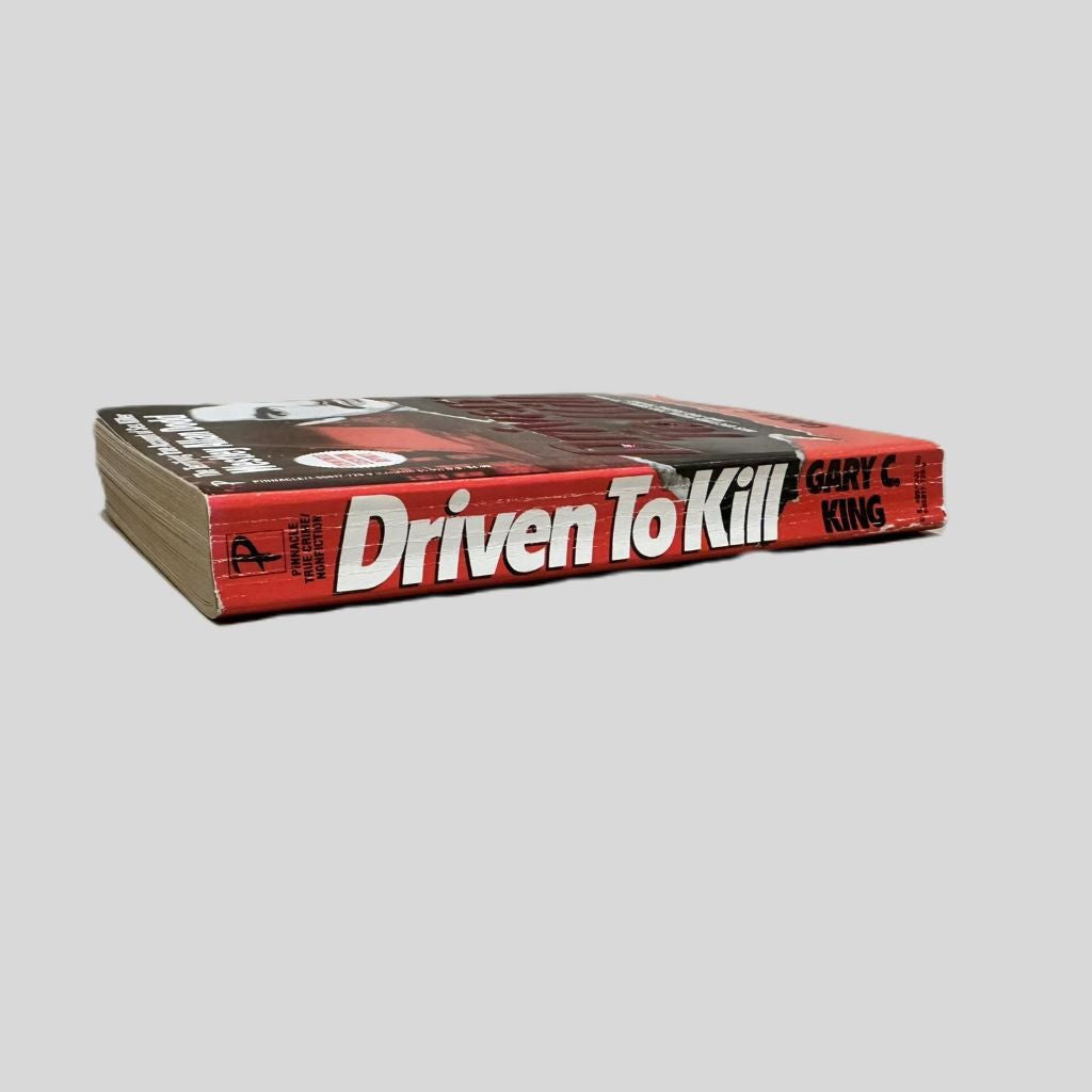 Close-up spine view of Driven to Kill by Gary C. King centered on a neutral light gray background. Spine shows creasing and bumping.