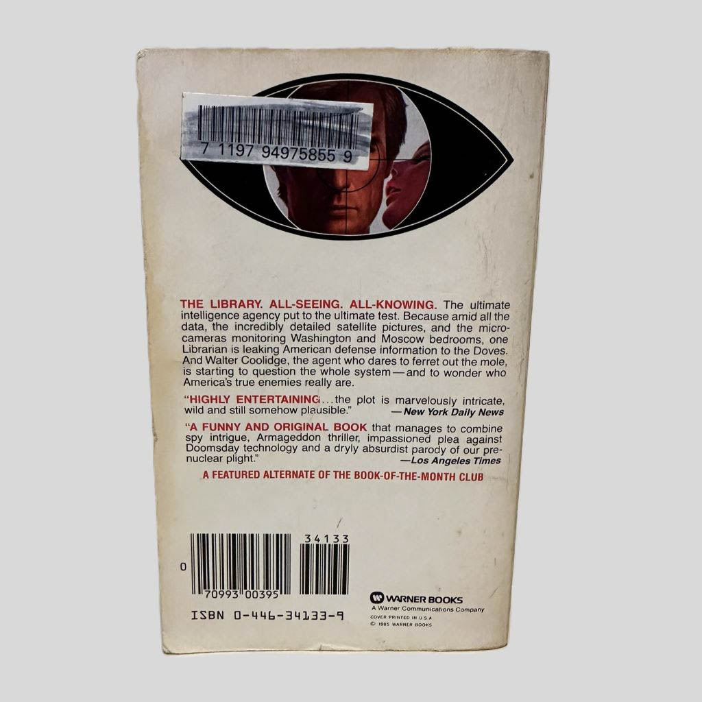 Back cover view of Dunn's Conundrum by Stan Lee centered on a neutral light gray background. Chipping and foxing present around the edges. Library barcode sticker in the top left corner, colored over with black ink.