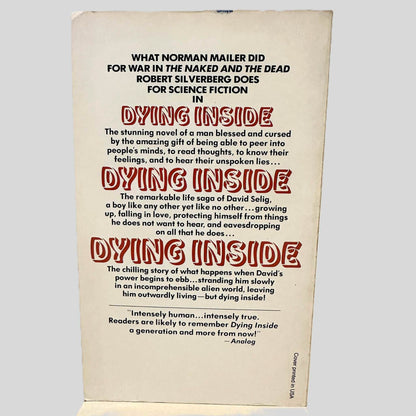 Back cover view of Dying Inside by Robert Silverberg centered on a neutral light gray background. Minor chipping is present and small crease to the tip of the top right corner.
