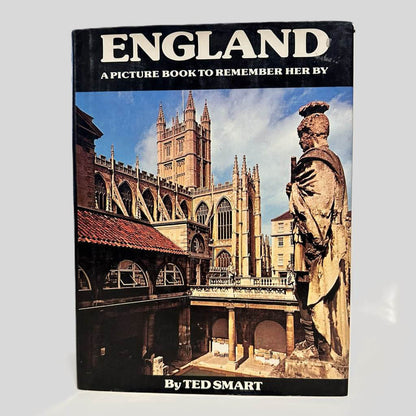 Front cover view of England a Picture Book to Remember Her By by Ted Smart centered on a neutral light gray background. Dust jacket is present. Chipping to the top right corner.