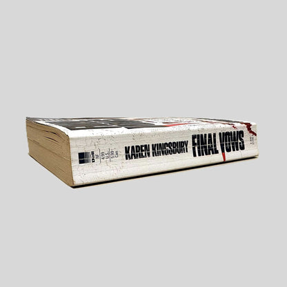 Close-up spine view of Final Vows by Karen Kingsbury centered on a neutral light gray background. Spine shows creasing.