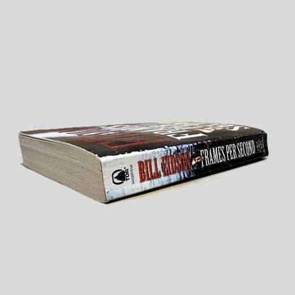 Close-up spine view of Frames Per Second by Bill Eidson centered on a neutral light gray background. Spine shows creasing.