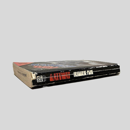 Close-up spine view of Gateway by Frederik Pohl centered on a neutral light gray background. Spine shows minimal creasing. Chipping to the top and bottom edges. Cocking is present. Pages lay flat.