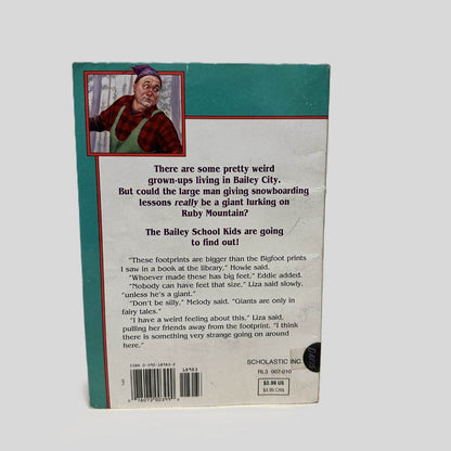 Back cover view of Giants Don't Go Snowboarding by Debbie Dadey and Marcia Thornton Jones centered on a neutral light gray background.  Chipping around the edges of the back cover.