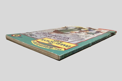 Close-up spine view of Giants Don't Go Snowboarding by Debbie Dadey and Marcia Thornton Jones centered on a neutral light gray background. Spine shows creasing. Pages lay flat.