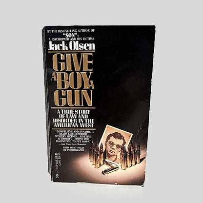 Front cover view of Give A Boy A Gun by Jack Olsen centered on a neutral light gray background. 