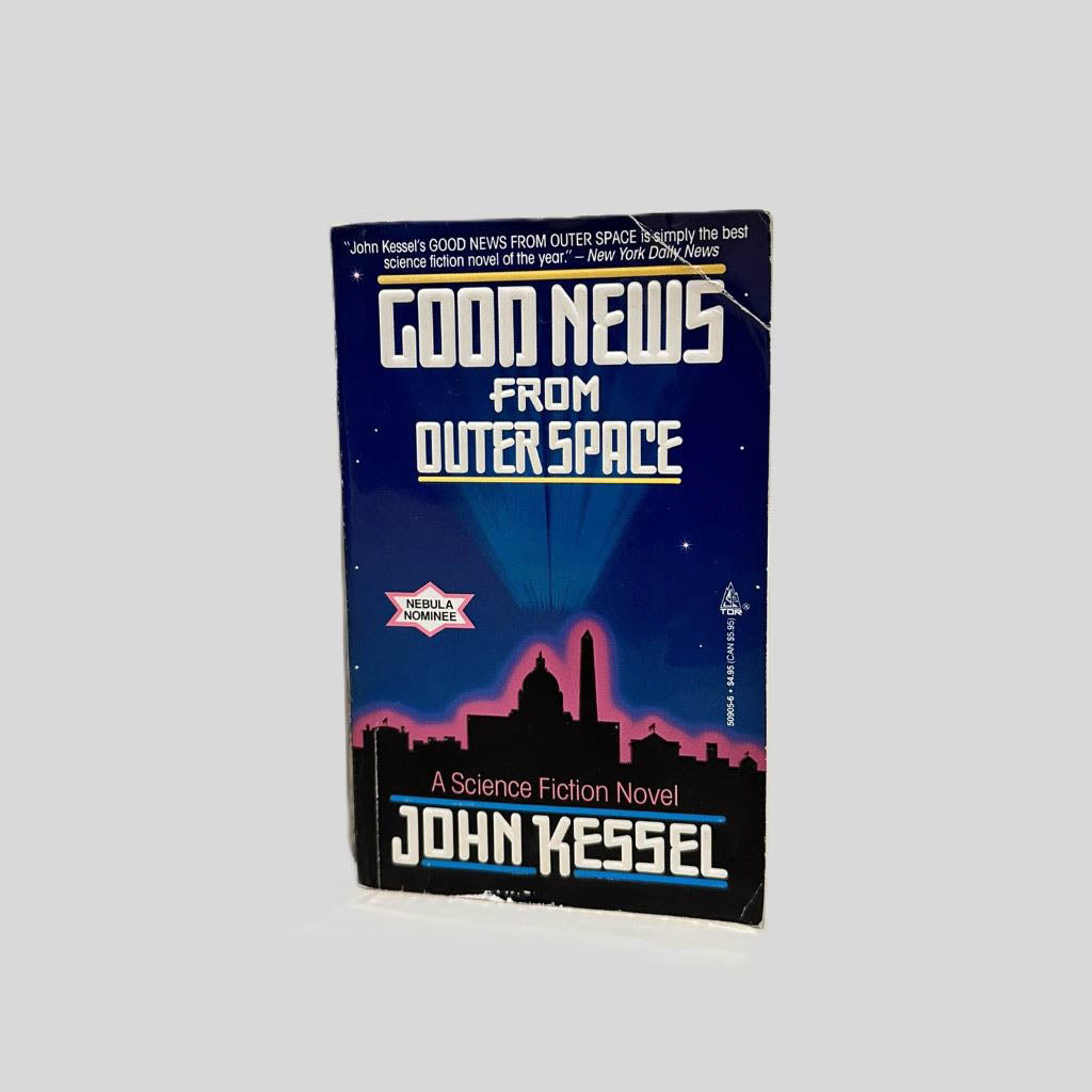 Front cover view of Good News from Outer Space by John Kessel centered on a neutral light gray background. Creasing at the top an bottom right corners. Chipping along the bottom edge. Cover art is vibrant.