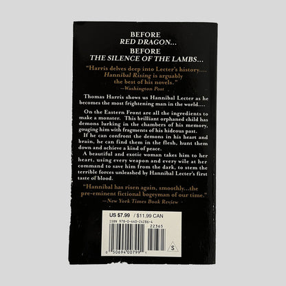 The black back cover of Hannibal Rising, featuring gold and white text that describes the book as the origin of Hannibal Lecter's evil.